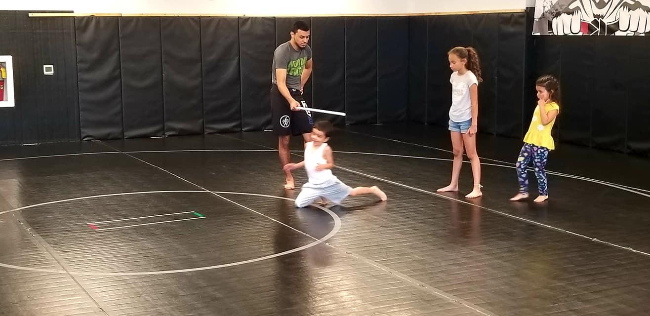 Kids training on the mats with their instructor